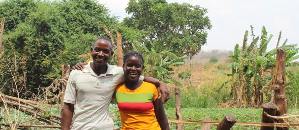 Leonard Banda and Sabina Zulu standing in front of their farm