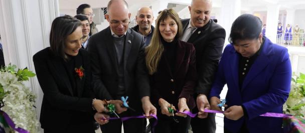 A group of people cutting a ribbon