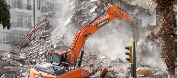 Earthmover digs through earthquake rubble