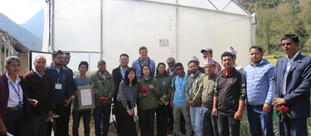 UNDP Nepal members and its partners standing infront of a polyhouse in Jajarkot