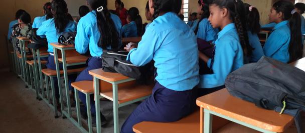Students sitting on a bench in a classroom