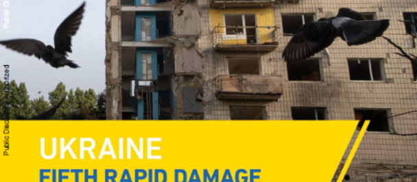 Ruined Ukrainian apartment block, birds in the sky, yellow banner about damage and needs.