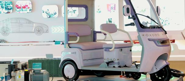 Pastel purple three-wheeled electric vehicle on display in showroom.