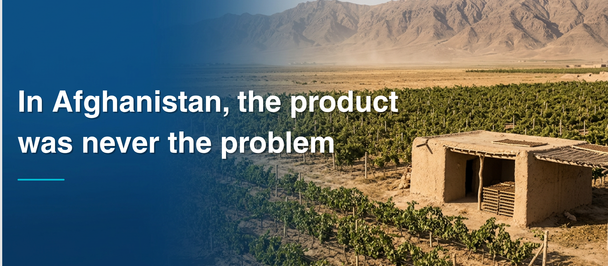 Banner with blue left panel over Afghanistan desert landscape and a small mud-brick building.