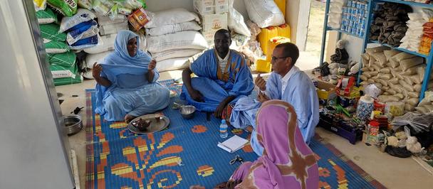 Group of several people sitting in a community shop