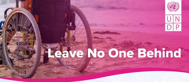 Wheelchair user on a pink banner with UNDP logo and 'Leave No One Behind'.