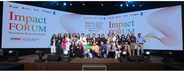 Group photo on a stage at Impact Forum with a branded backdrop.