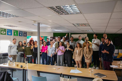 a group of people standing around a table