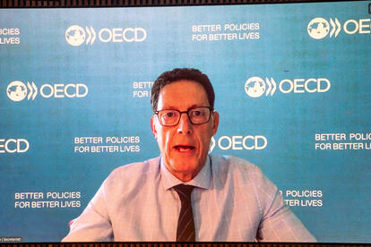 Photograph of a man in a shirt, tie, and glasses speaking in front of an OECD backdrop.Ben Dickinson, Deputy Director of the OECD Centre for Tax Policy and Administration (CTPA);