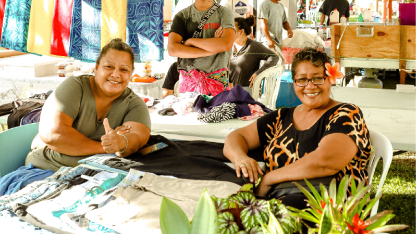 UNDP Samoa three people posing surrounded by clothes and plants
