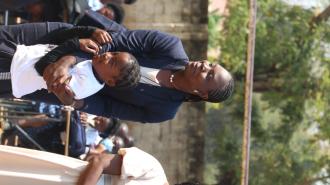 Head of Inclusive and Sustainable Growth, Chali Chisala Selisho, embracing a student of Jacaranda Combined School during a road safety demonstration at the Launch of Safe Schools Infrastructural Improvements in Lusaka