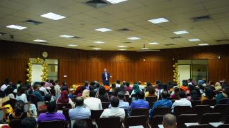UNDP Bangladesh sitting in audience with man on stage