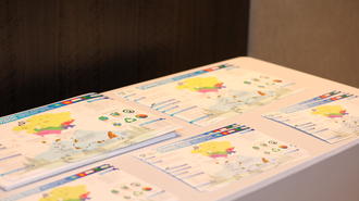 Several colorful certificates spread on a white table.