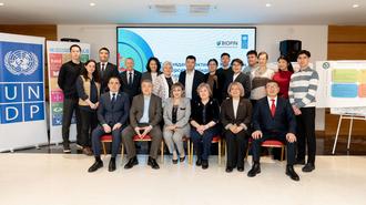 Group photo of officials in a conference room with a UNDP banner on the left.