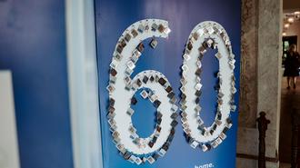 Blue banner with a large, flower-covered 60 for a 60th anniversary.