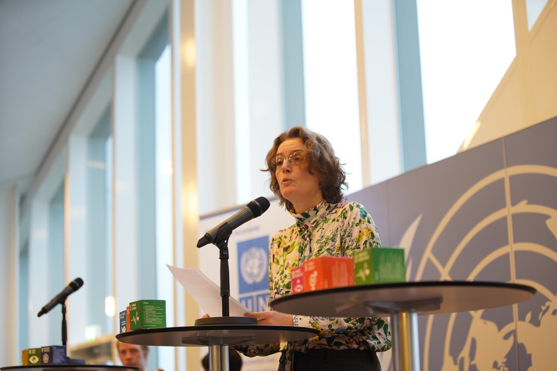 Woman speaking in front of audience
