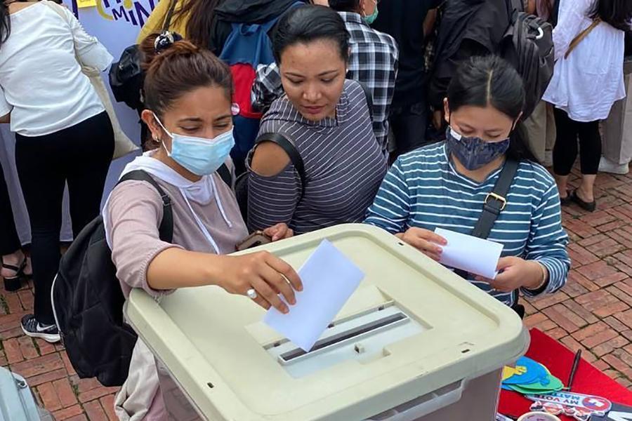 3 people behind a box