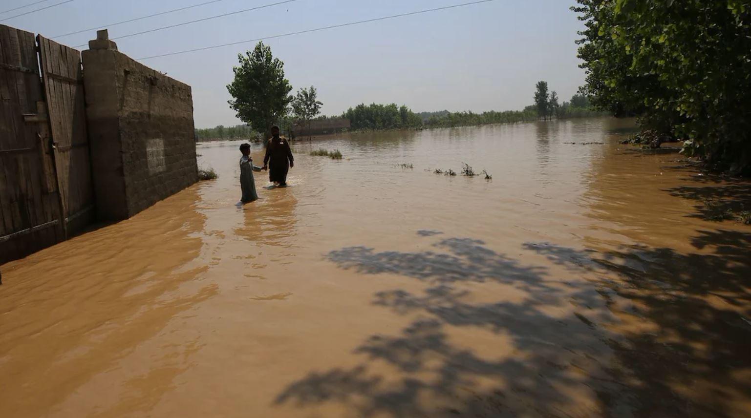 Flooded landscape with people in the distance