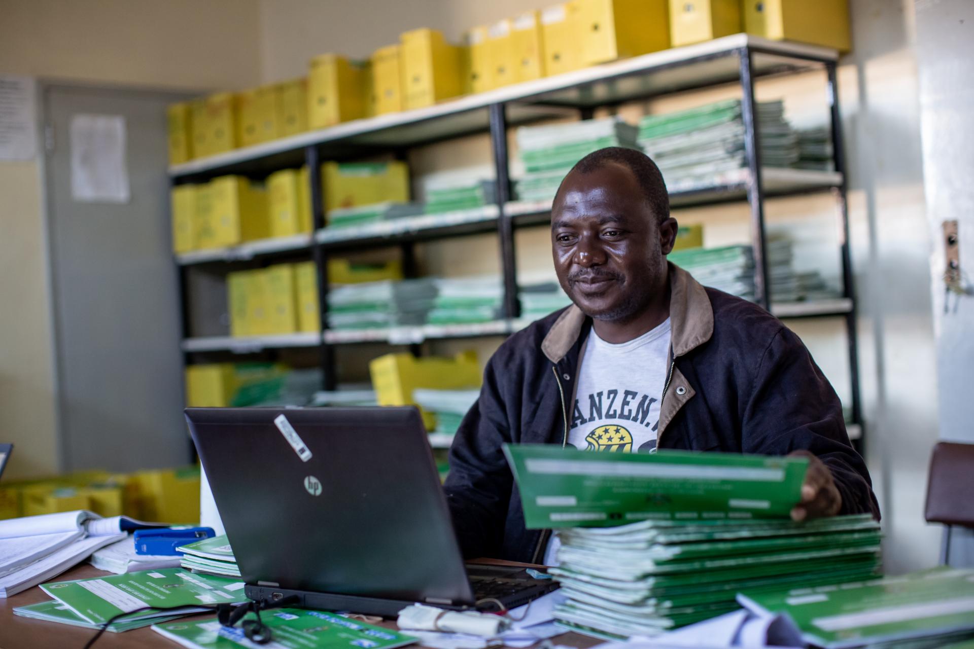 a man managing solar energy registration on a computer