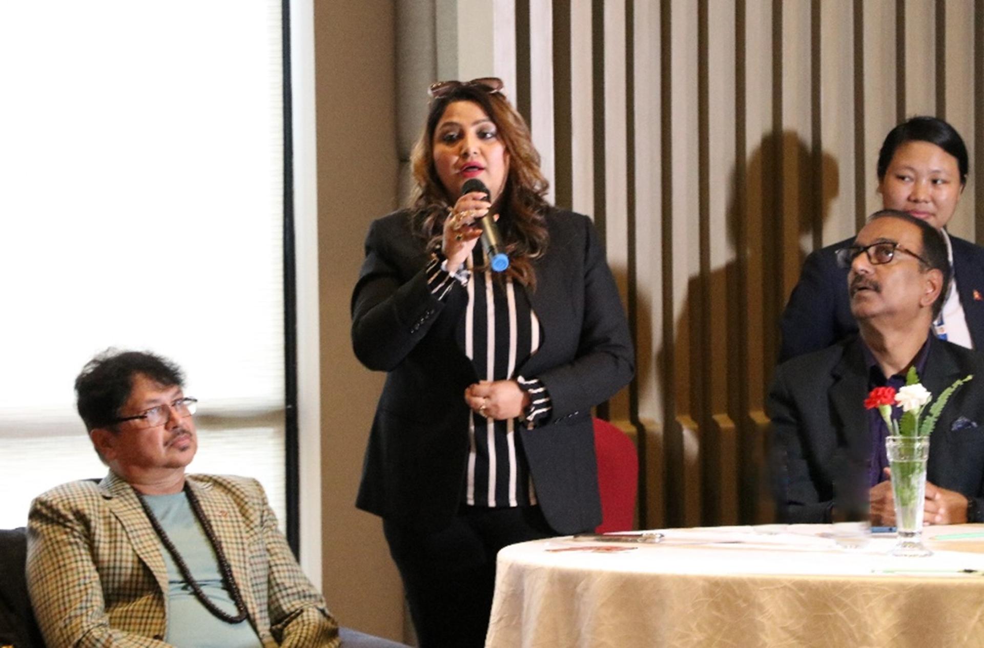 a woman speaking while three people listening