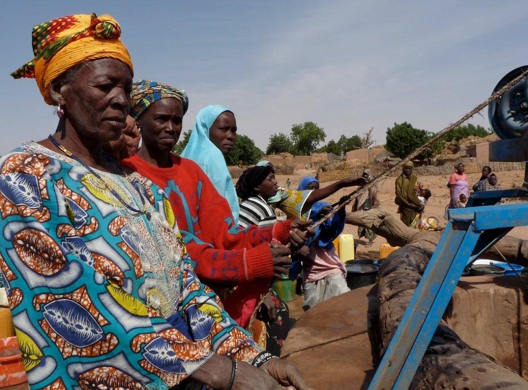 Women pulling water out of a well