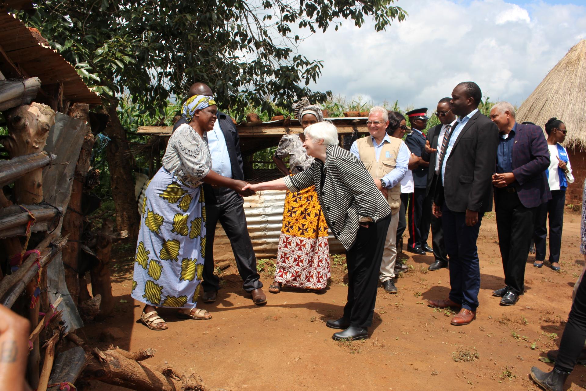 US Secretary of Treasury, Dr. Janet Yellen, greets a SCRALA project beneficiary at her homestead in Chongwe, Zambia