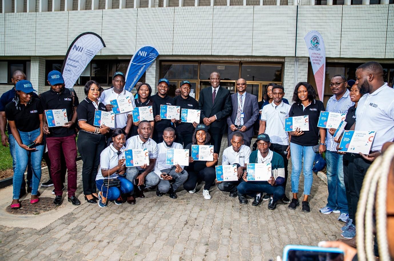 An image of Honourable Minister of Technology and Science, Felix Mutati (centre) flanked by the awarded innovators of 2022.