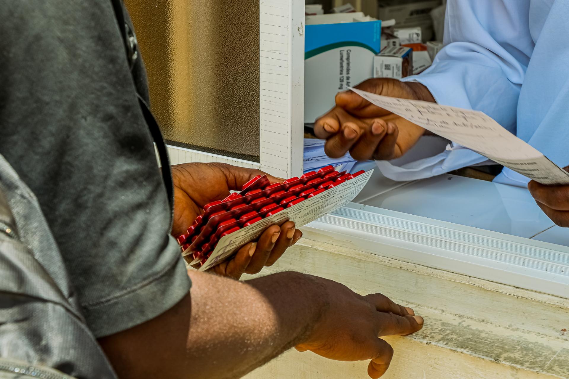 Closeup showing patient receiving TB medication from a clinic.