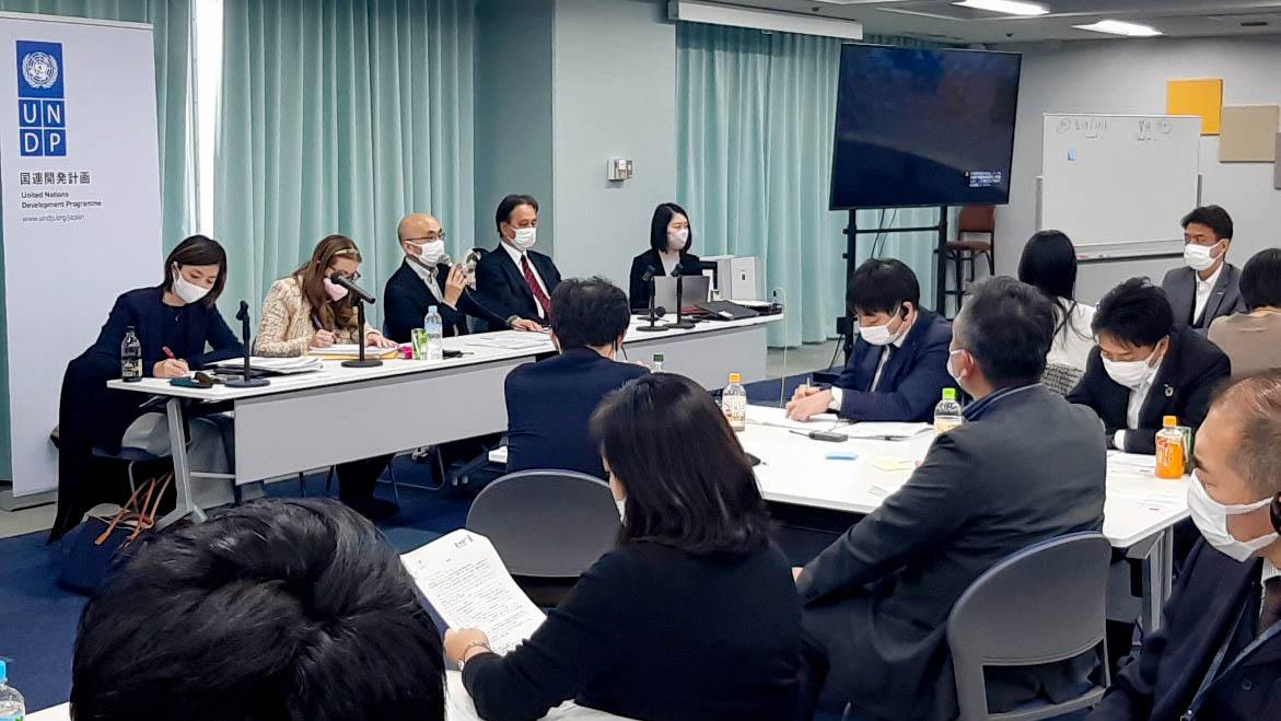 Training session with panel of speakers in front of room of participants