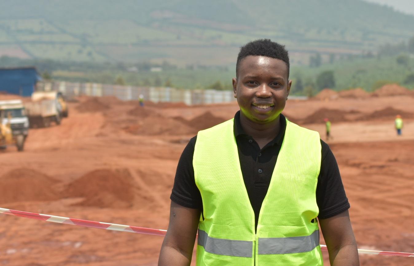 Tafara wearing a green vest at a job site