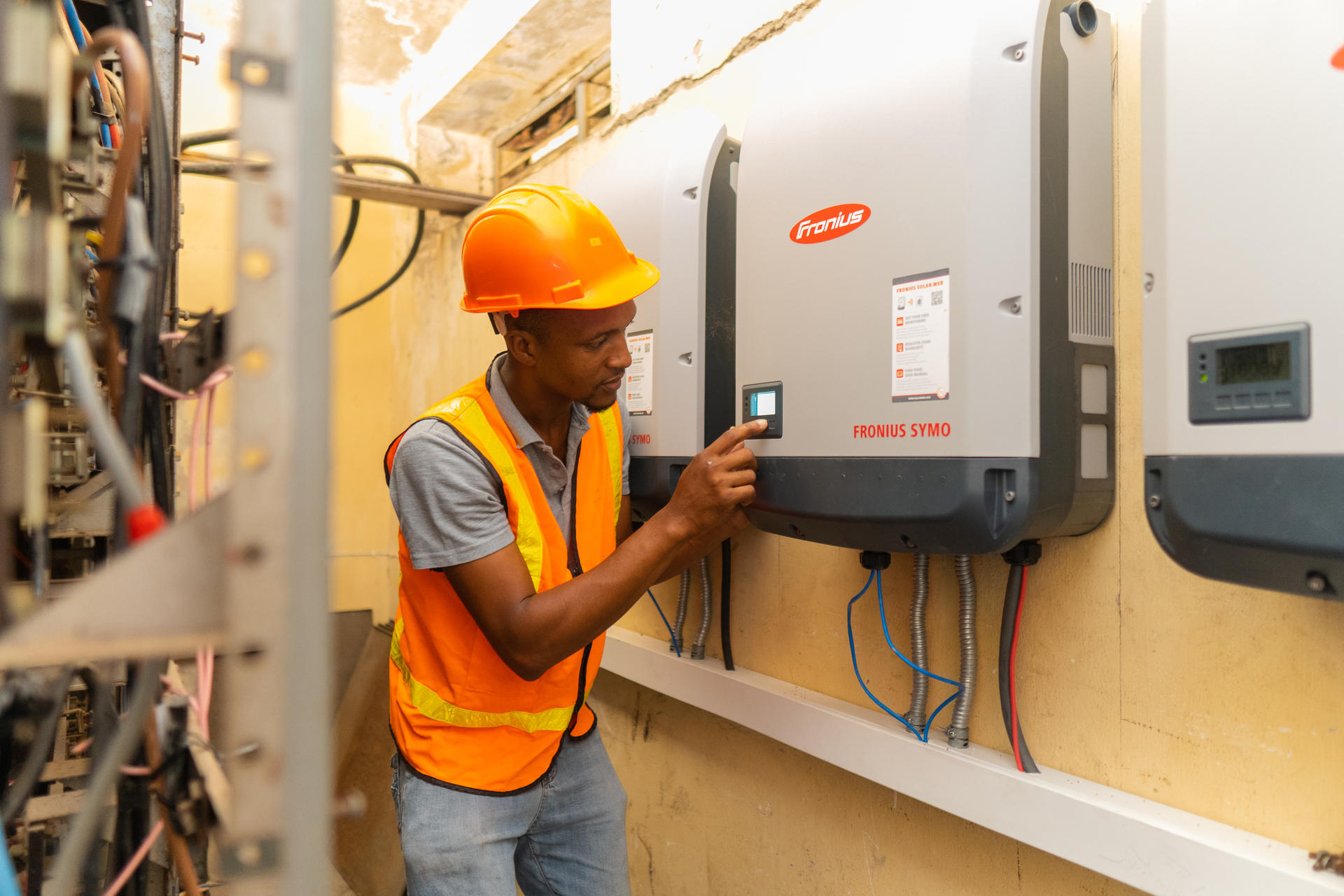 Damion Lawrence, Maintenance Supervisor at the Sir John Golding Rehabilitation Centre, inspecting the solar panel system
