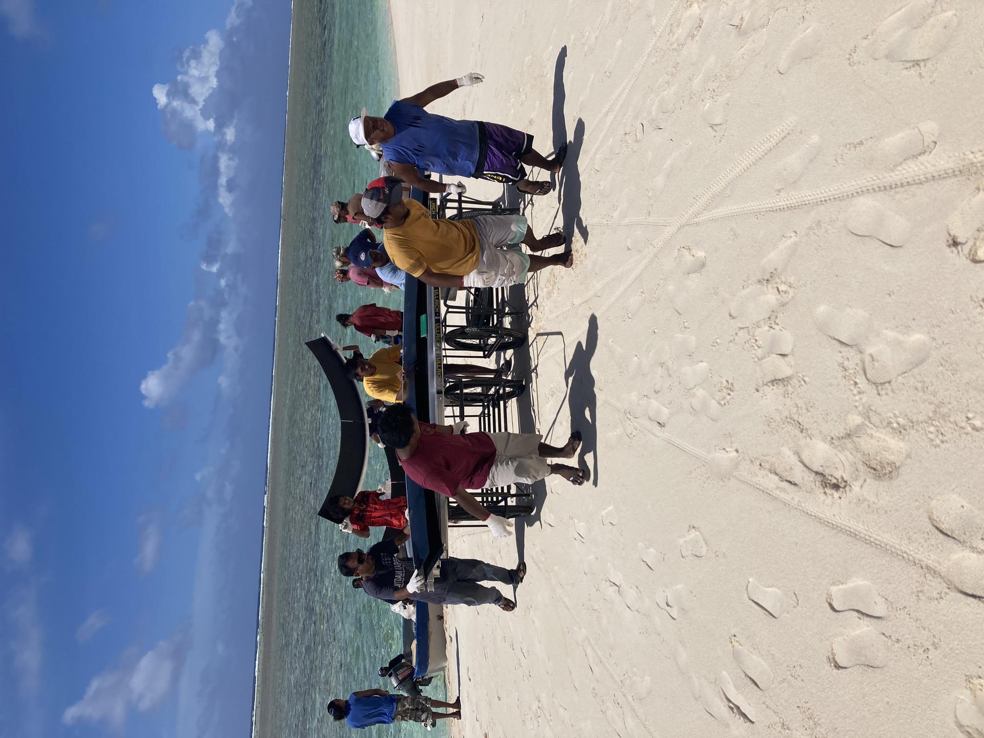Transporting materials of flatpack modular tanks by community workers at Namu Atoll