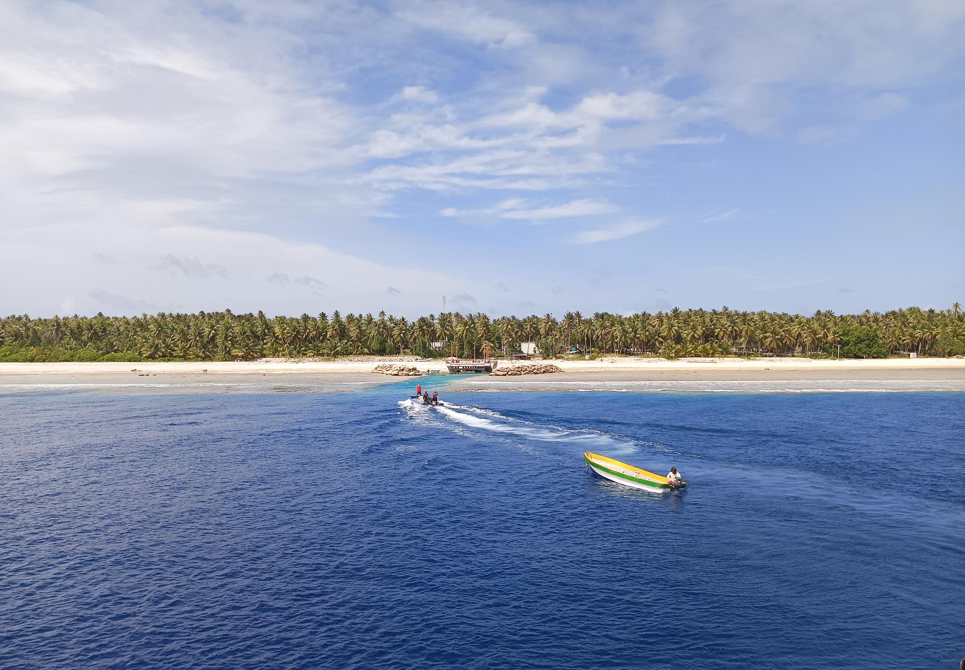 Unloading materials from the vessel to small boat to access shallow waters at Lib Island.