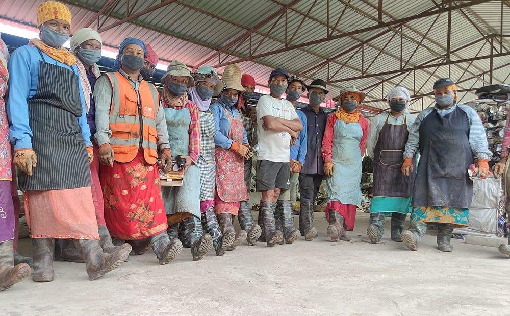 Women and men in a row showing their boots