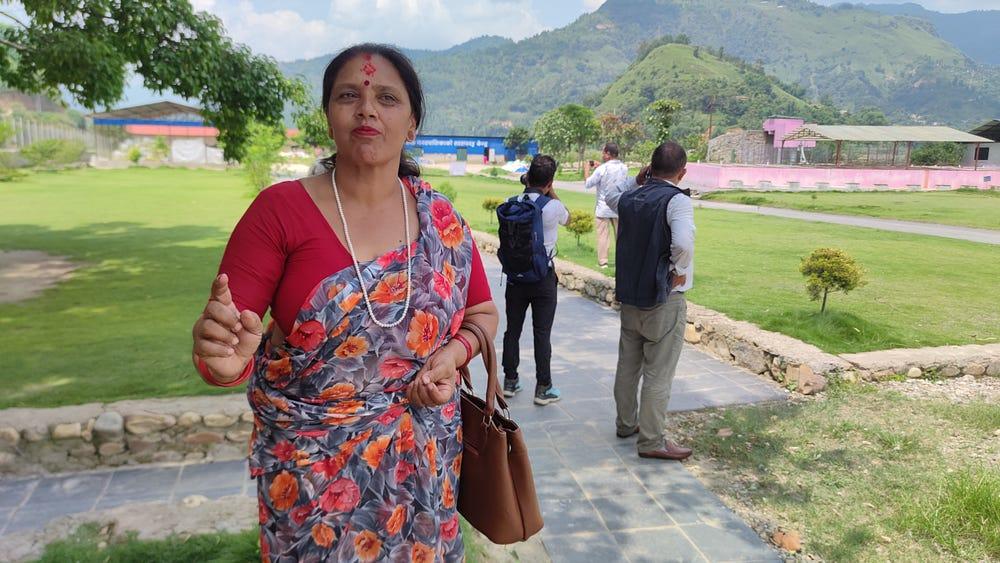 A women talking and two men in background
