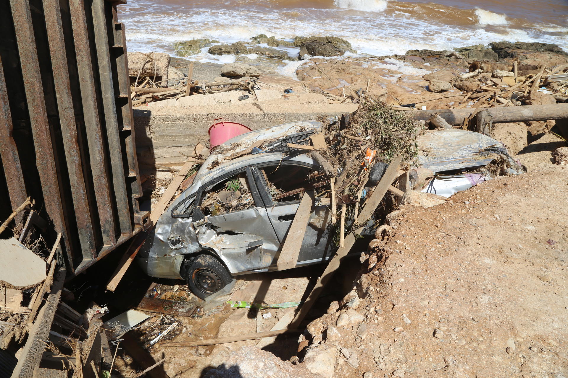 Destroyed car covered in debris
