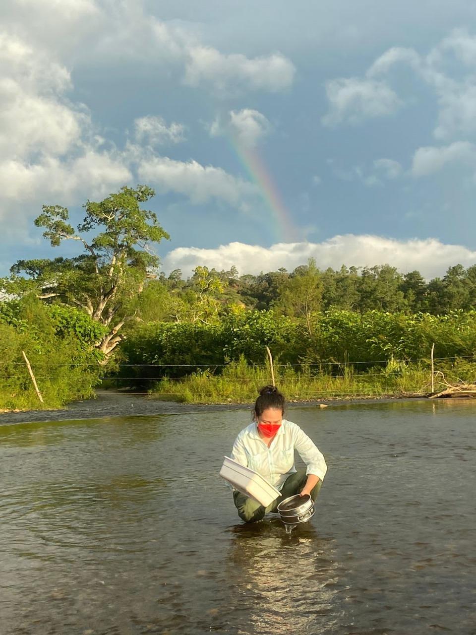 Person standing waist deep in river