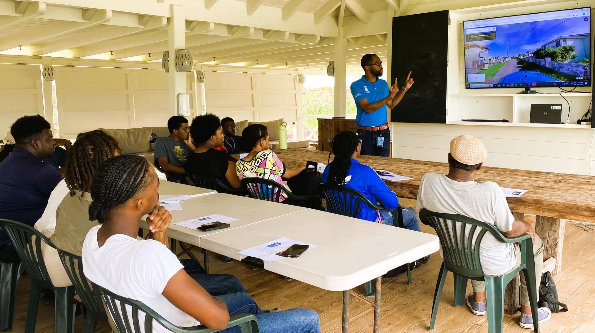 Man making a presentation to seated class