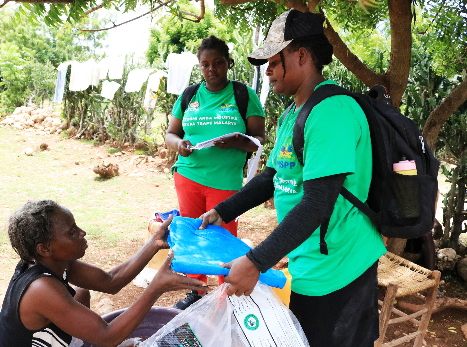 Women delivering bed nets