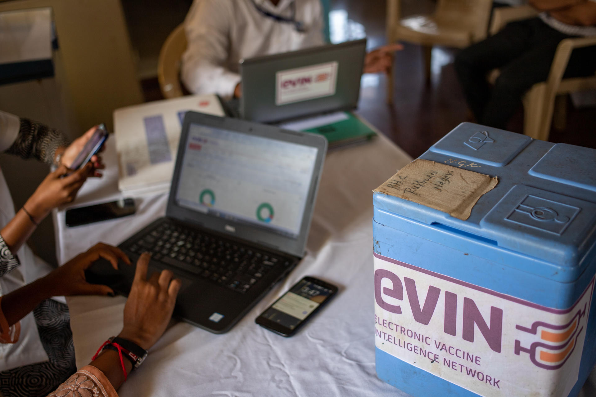 Laptop computer next to box labelled eVin