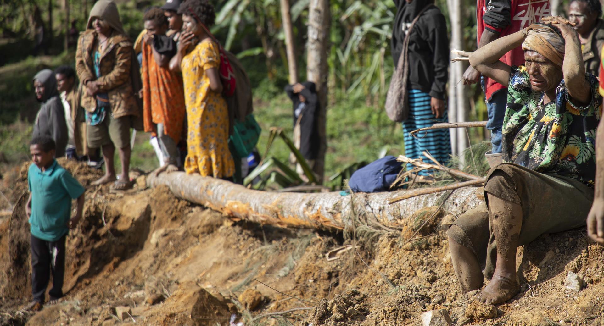 Distraught survivors of a landslide in Papua New Guinea