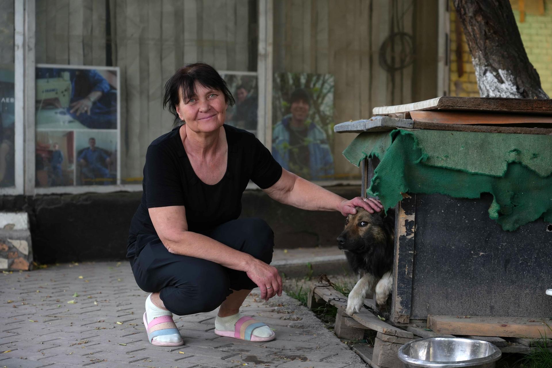 a woman holding an animal