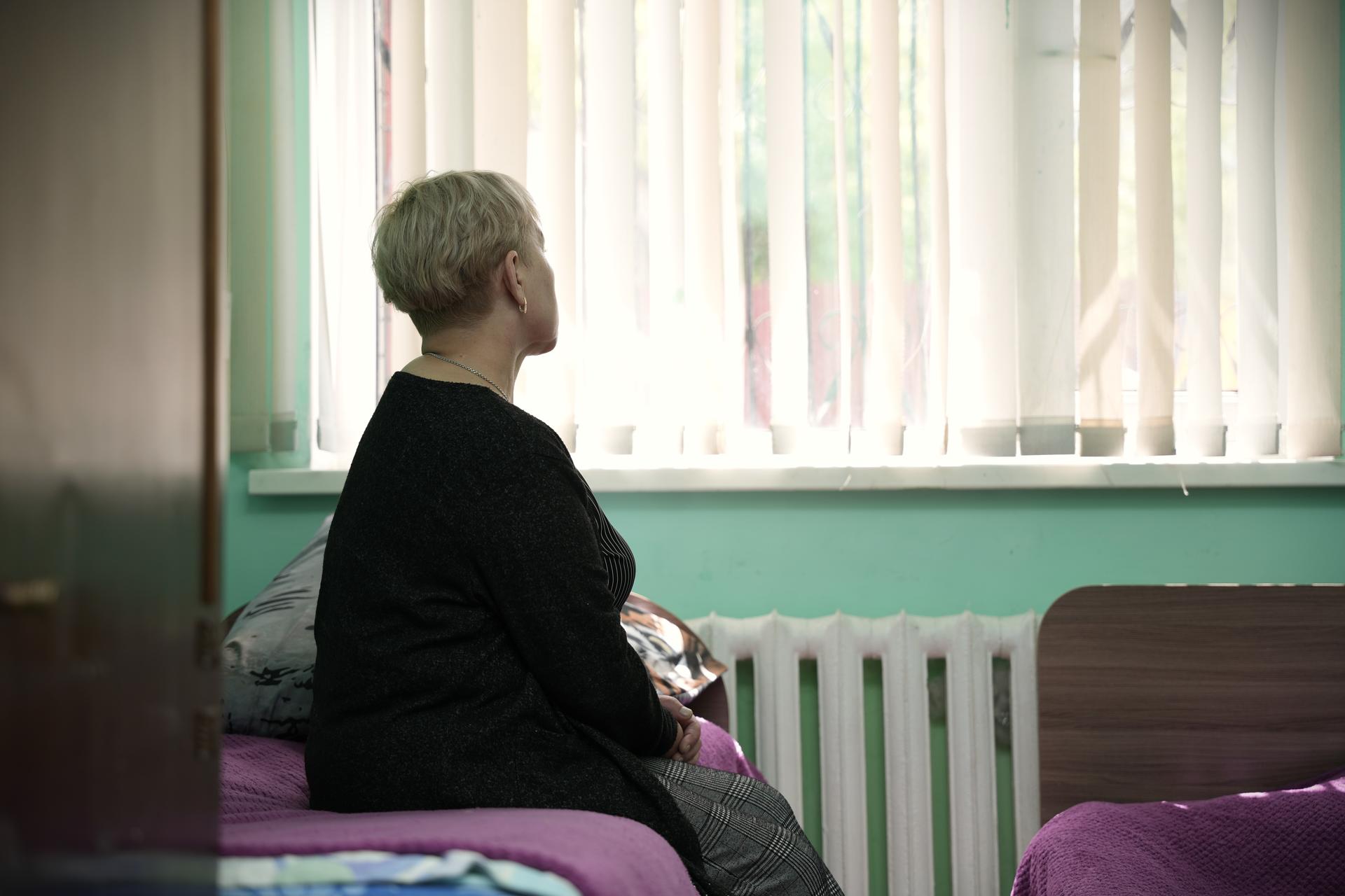 a person sitting in front of a window
