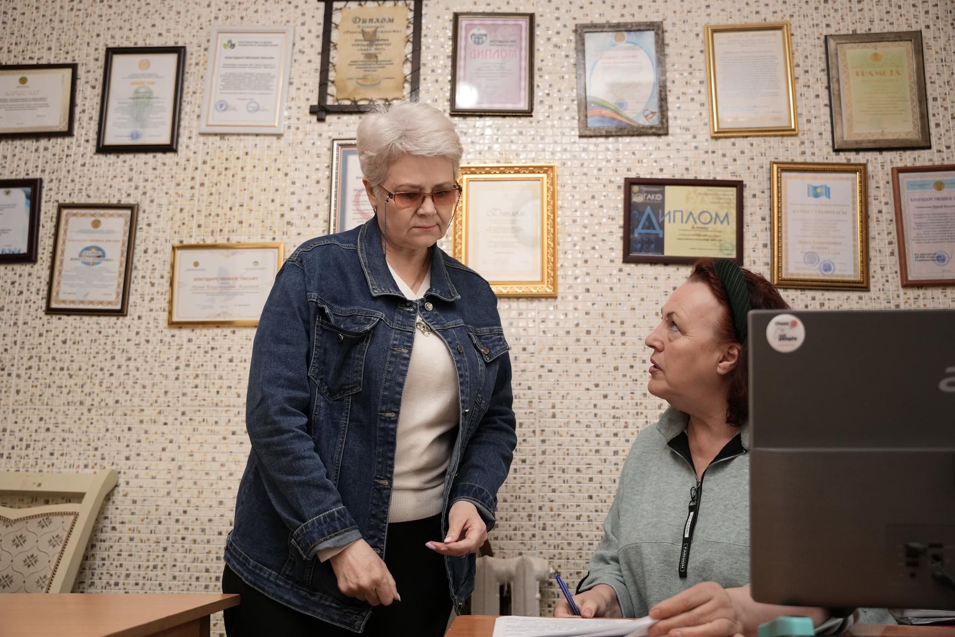 a man and a woman standing in front of a table
