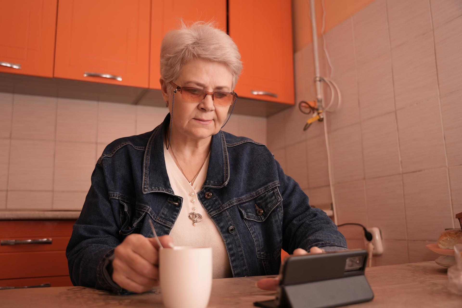 a woman sitting at a table with a cup of coffee