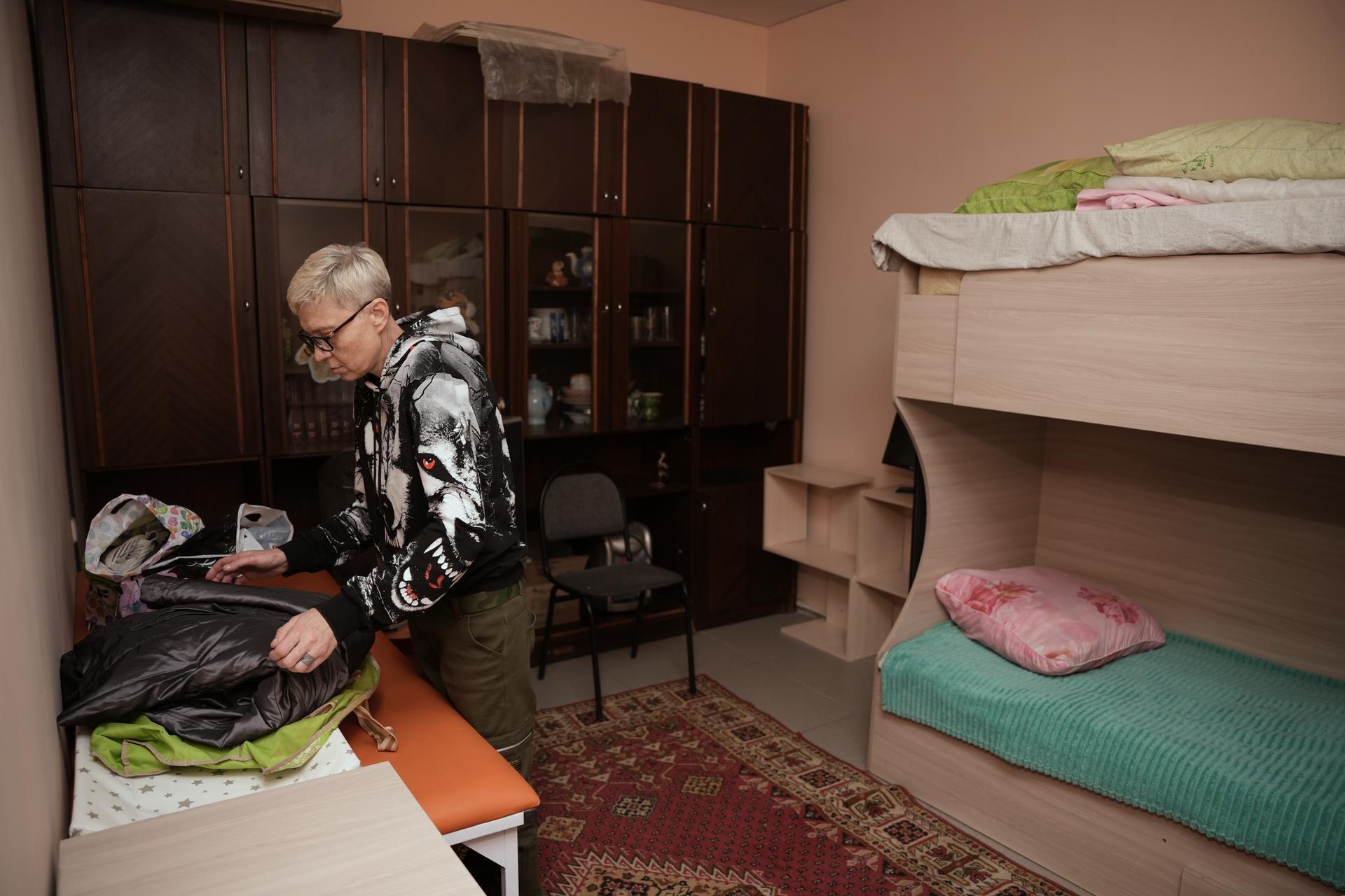 a person sitting on a bed in a room