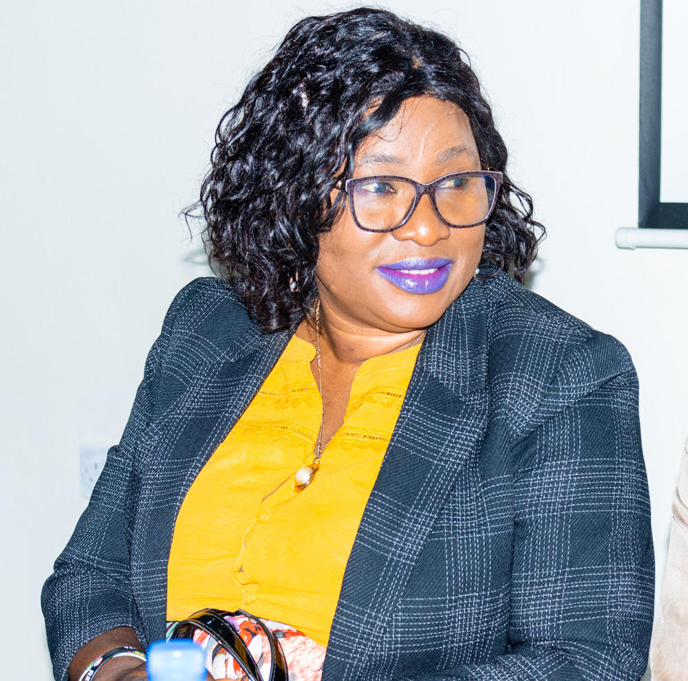 a woman wearing glasses and smiling at the camera
