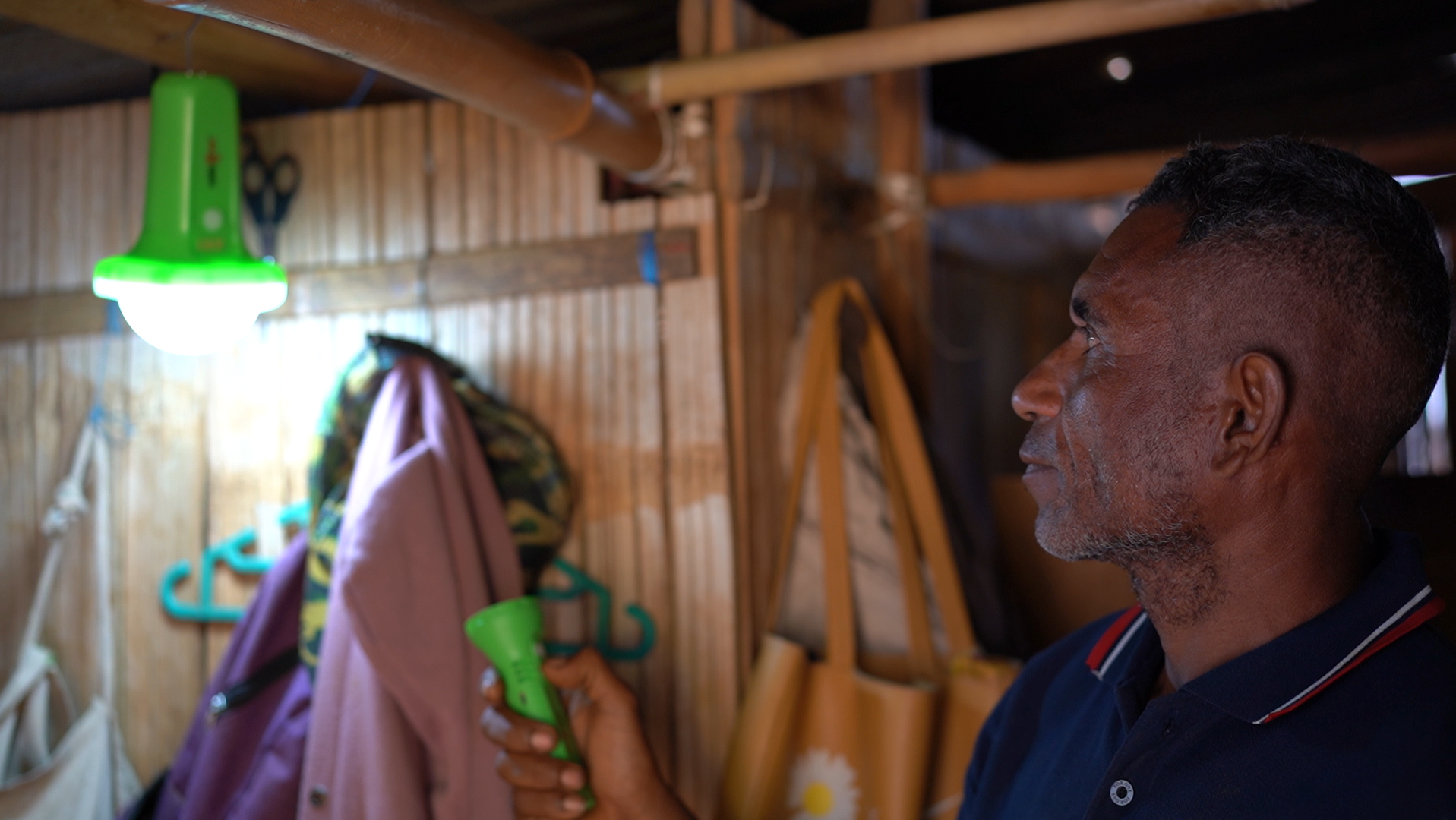 Men staring at light in rural area of Timor-Leste