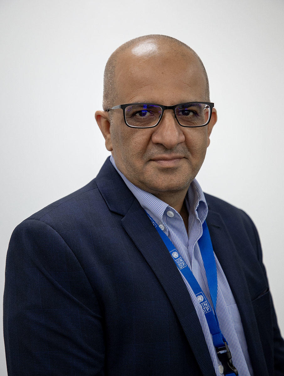 a man wearing glasses and a suit