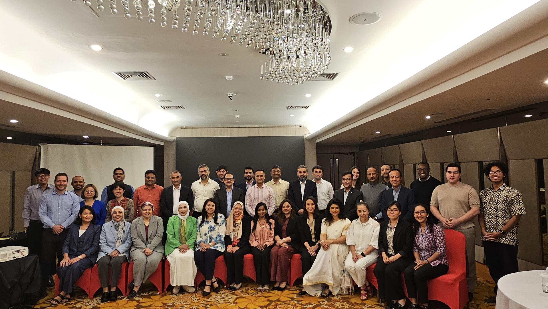 the participants of the event sitting and standing next to each other